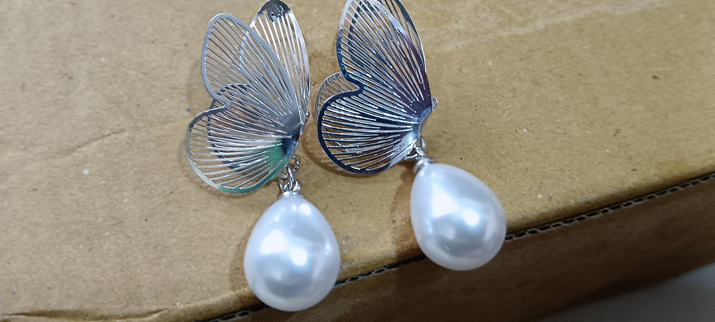 "Whispering Wings Pearl Drop Earrings"